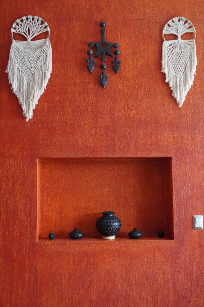 Red feature wall dividing the living and dining areas at LunaCoral Surf House