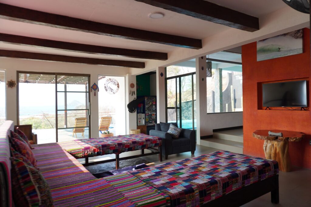 Living room at LunaCoral Surf House in Salina Cruz with colorful Oaxacan textiles and ocean views