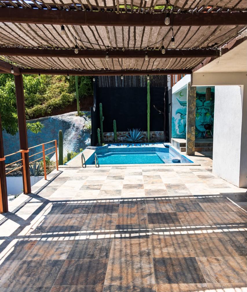 Swimming pool and outdoor patio at LunaCoral Surf House in Salina Cruz