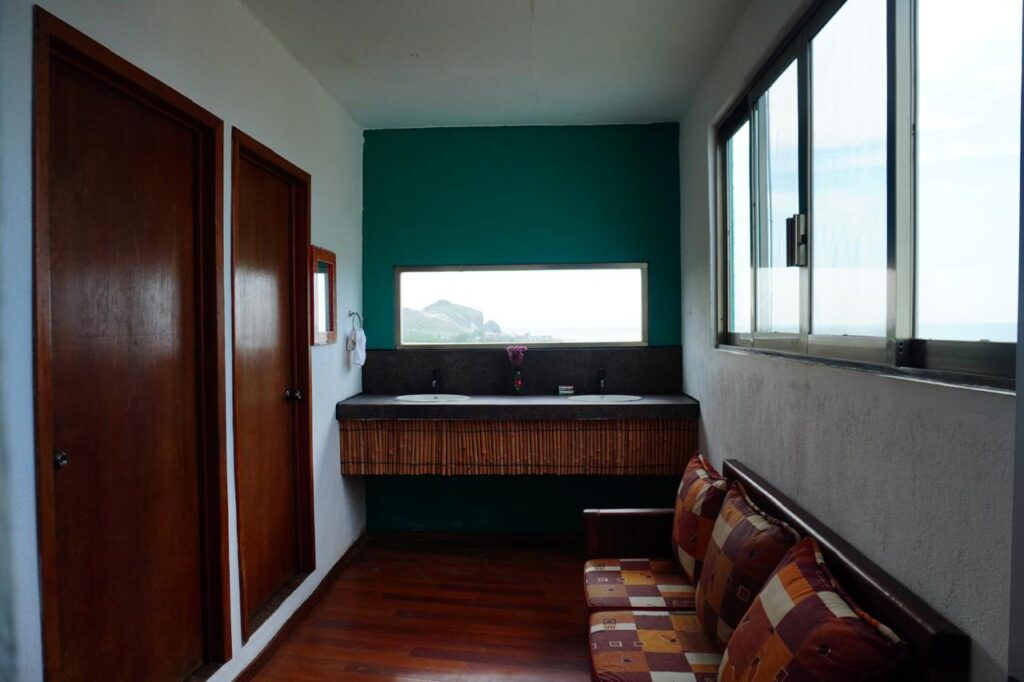 Private bathroom at LunaCoral Surf House with separate sink, shower and toilet areas in Salina Cruz, Oaxaca