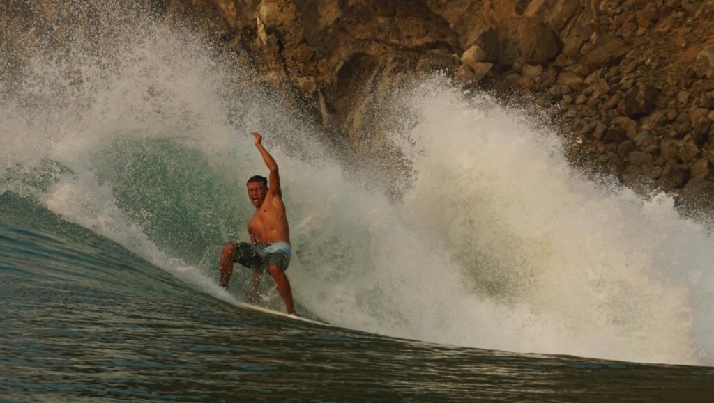 Surfer riding a remote wave during a boat trip in Salina Cruz, Oaxaca