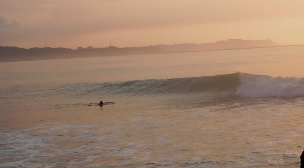 Surfer paddling at first light in Salina Cruz during a LunaCoral surf trip