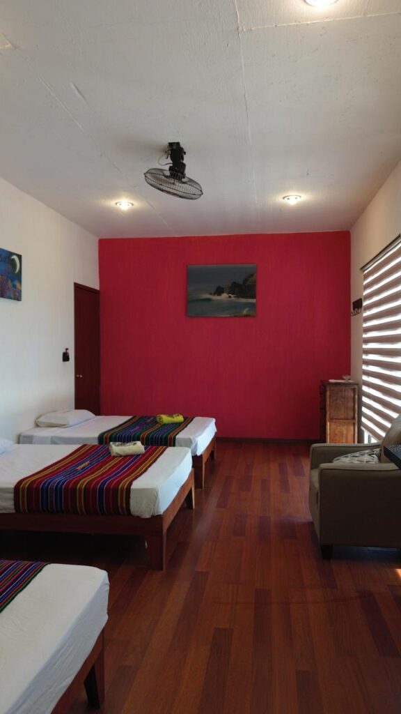 La Escondida triple room at LunaCoral Surf House in Salina Cruz with three double beds