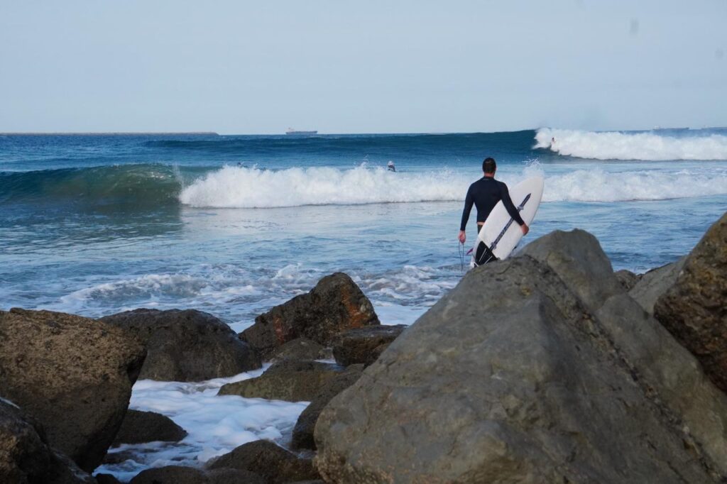 Surfer entering the water during a Salina Cruz surf trip